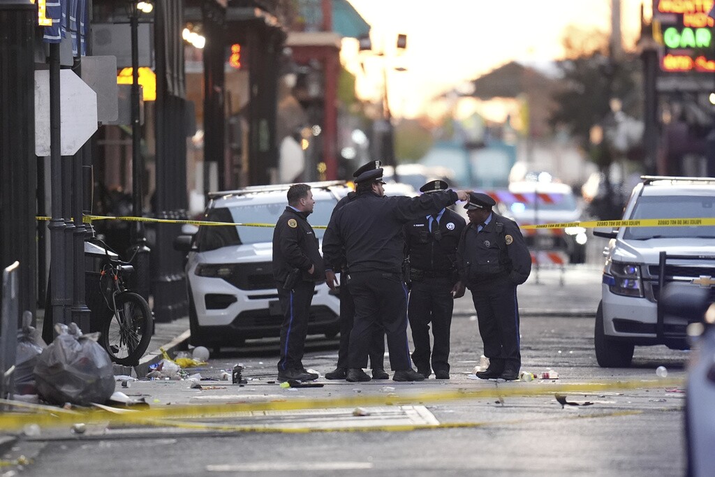 Security personnel gather at the scene on Bourbon Street after a vehicle drove into a crowd on New Orleans' Canal and Bourbon Street, Wednesday Jan. 1, 2025.