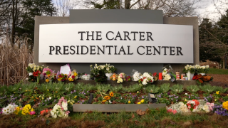 Flowers lie outside The Carter Presidential Center