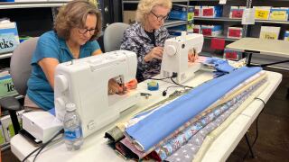 volunteers sewing pillowcases